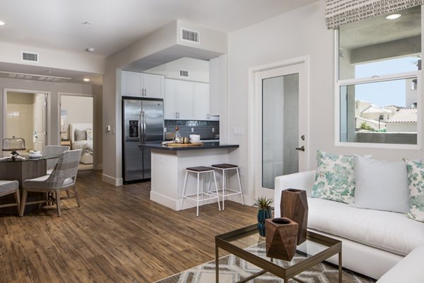 Spacious living room with modern furnishings at Sorano Apartments