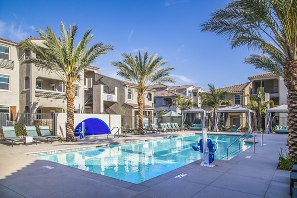 Luxurious outdoor pool with loungers at Sorano Apartments, a Greystar property