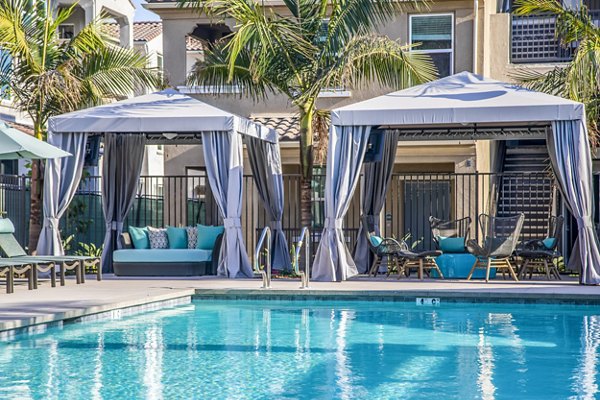 Resort-style pool with sun loungers at Sorano Apartments luxury community