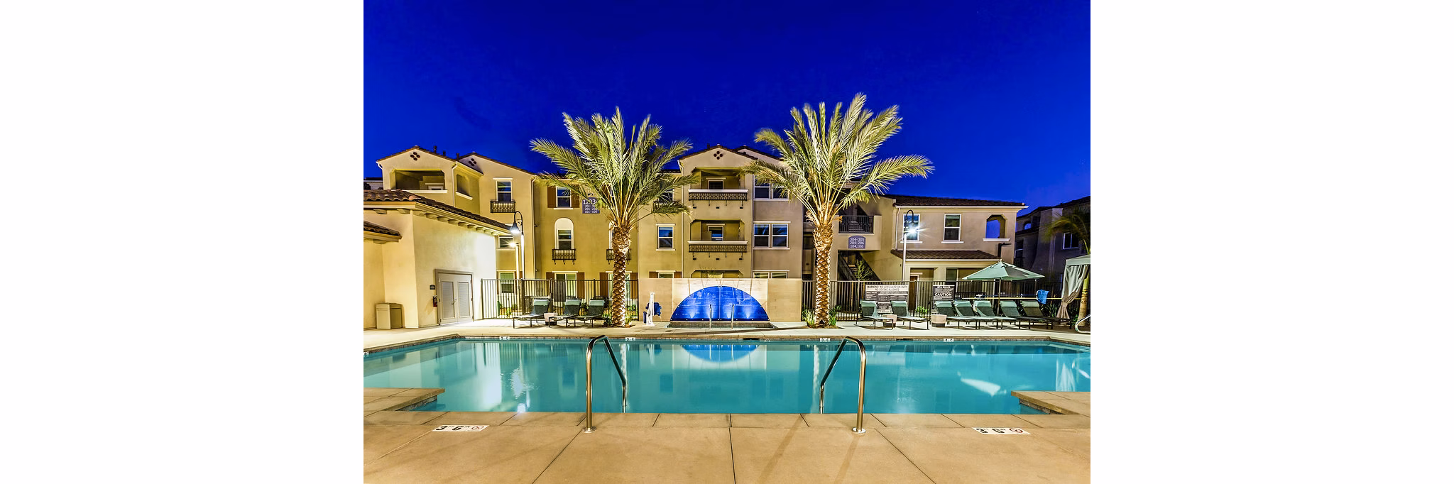 Modern pool with loungers at Sorano Apartments in luxurious setting
