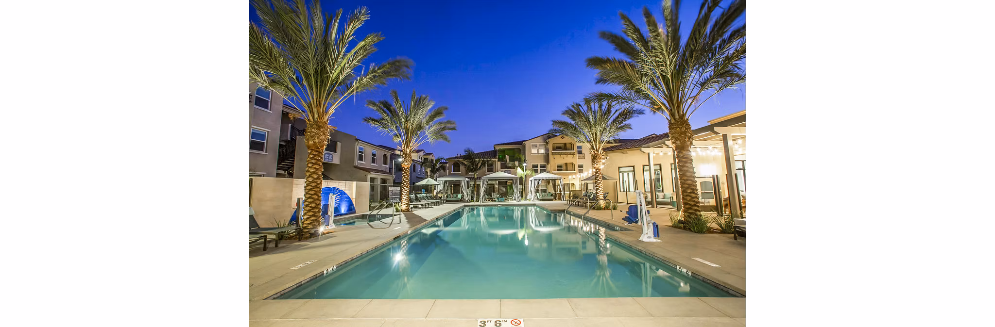 Inviting outdoor pool with lounge chairs at Sorano Apartments, luxury living in a tranquil setting