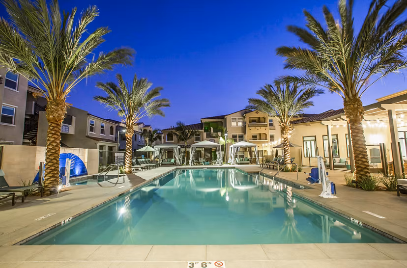 Inviting outdoor pool with lounge chairs at Sorano Apartments, luxury living in a tranquil setting