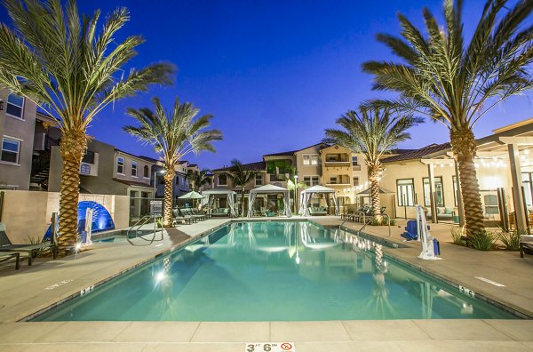 Inviting outdoor pool with lounge chairs at Sorano Apartments, luxury living in a tranquil setting