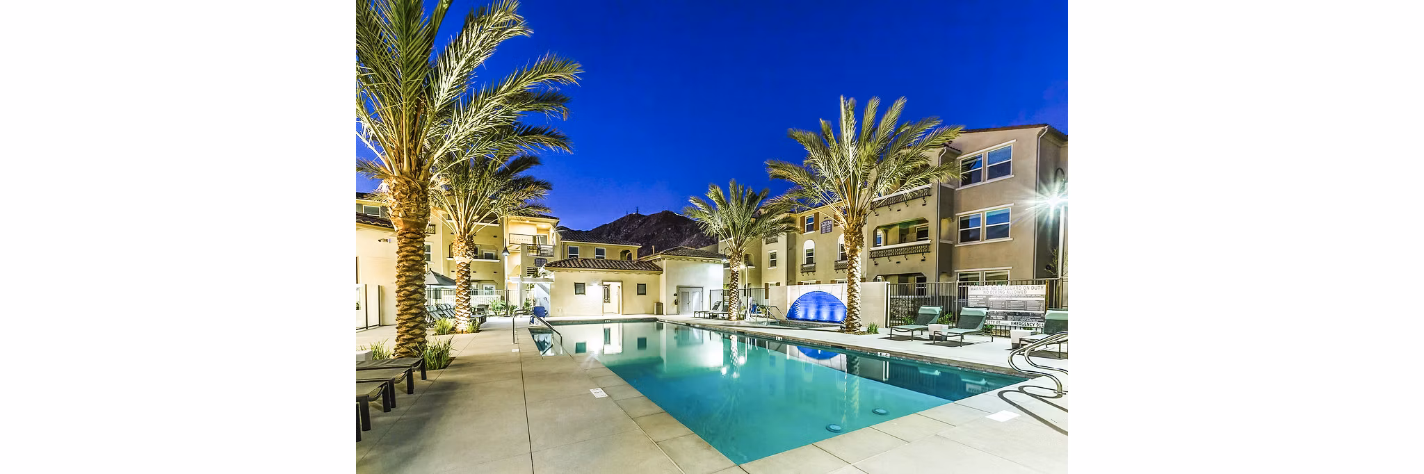 Resort-style pool at Sorano Apartments offering relaxing outdoor seating and lush landscaping