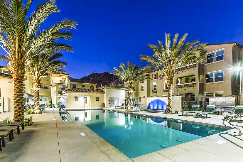 Resort-style pool at Sorano Apartments offering relaxing outdoor seating and lush landscaping