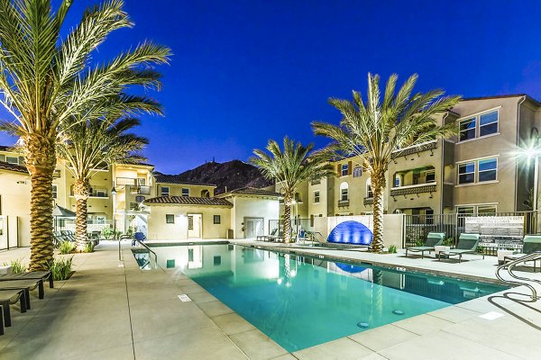 Resort-style pool at Sorano Apartments offering relaxing outdoor seating and lush landscaping
