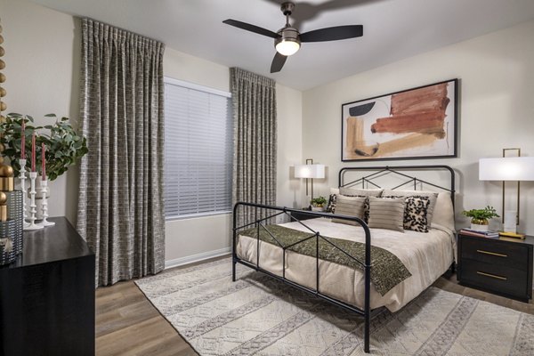 Cozy bedroom featuring modern furnishings and natural light at Tuscany Ridge Apartments