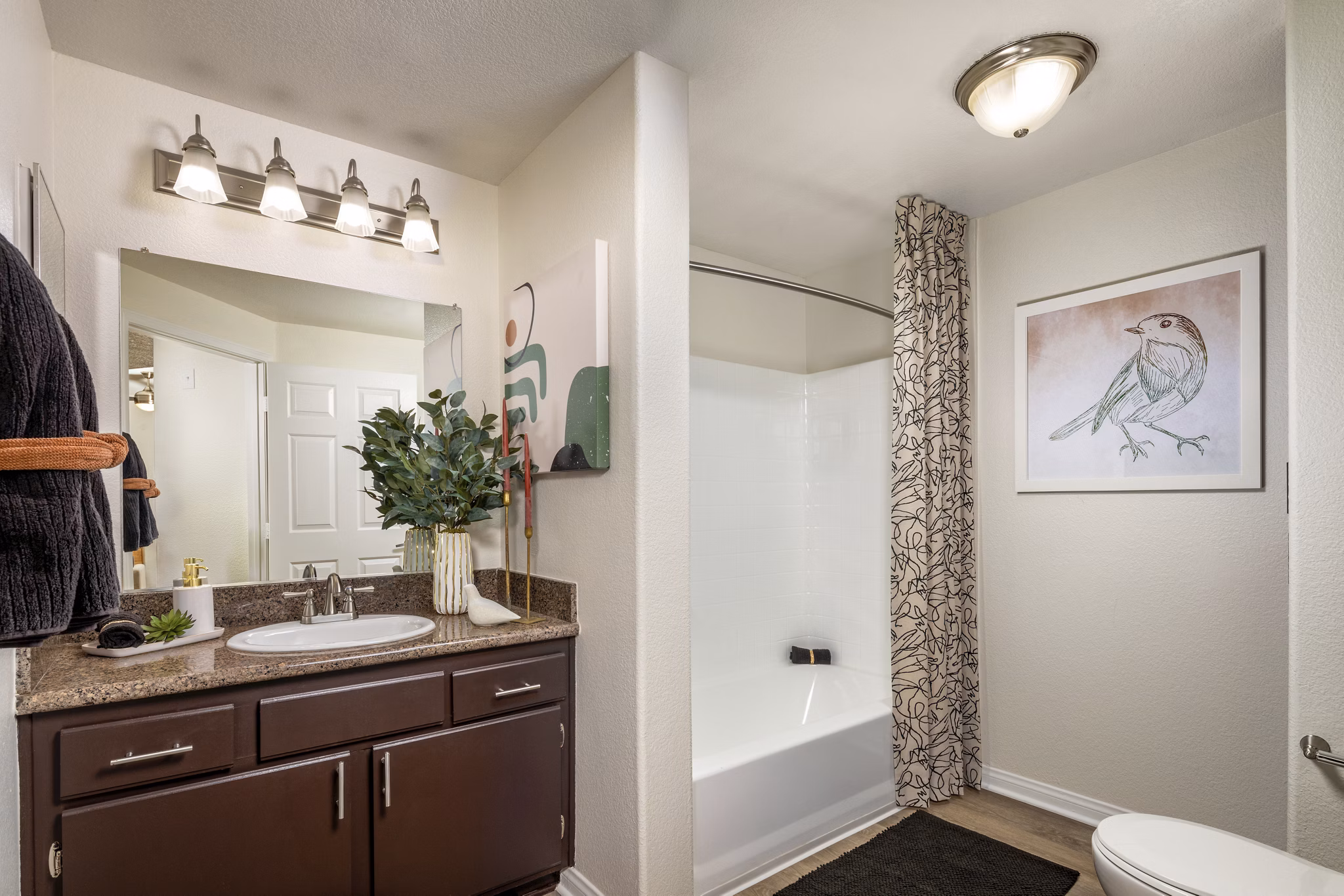 Spacious bathroom with modern fixtures and artwork in luxury apartment setting