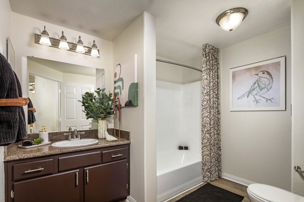 Spacious bathroom with modern fixtures and artwork in luxury apartment setting