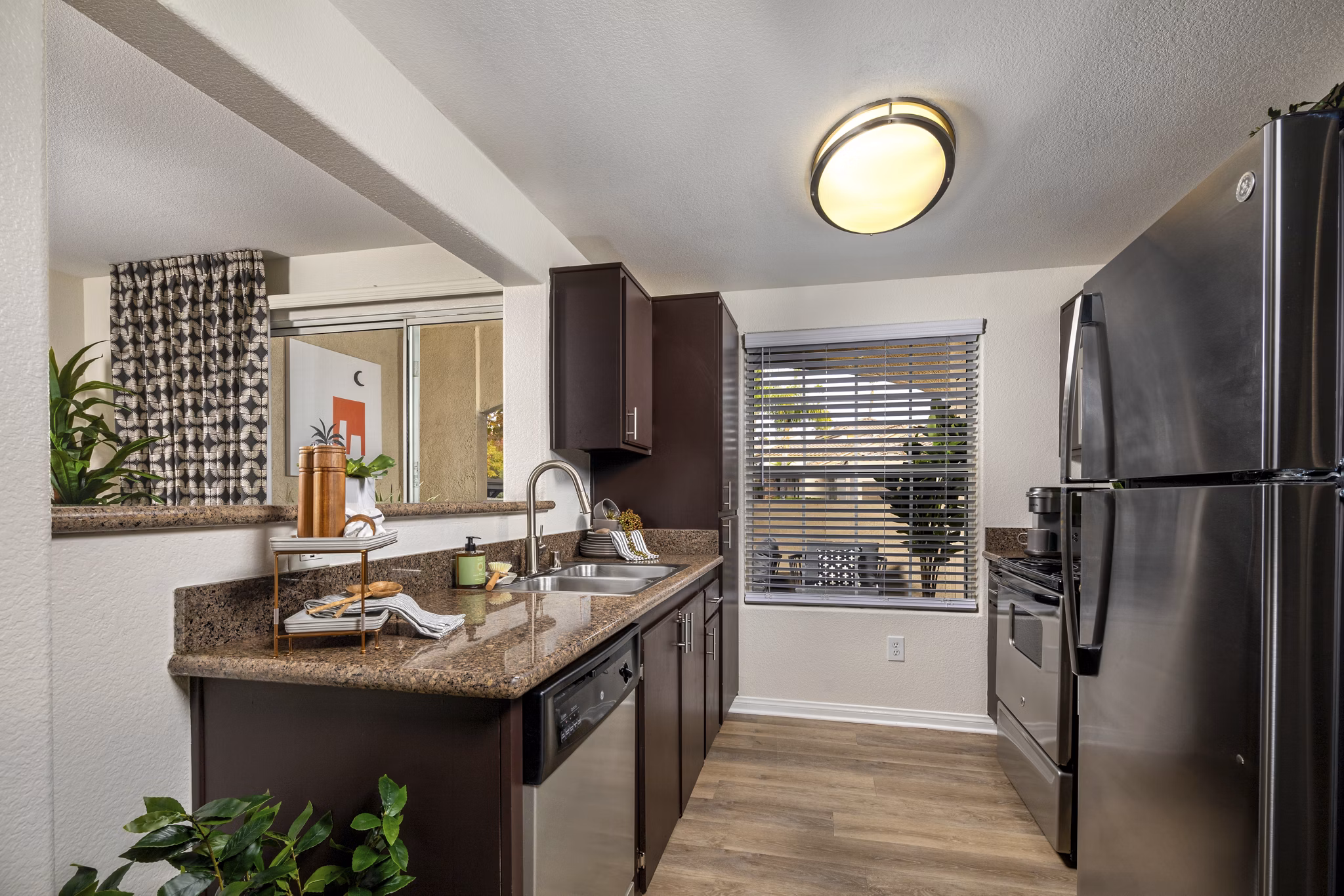 Modern kitchen with stainless steel appliances at Tuscany Ridge Apartments