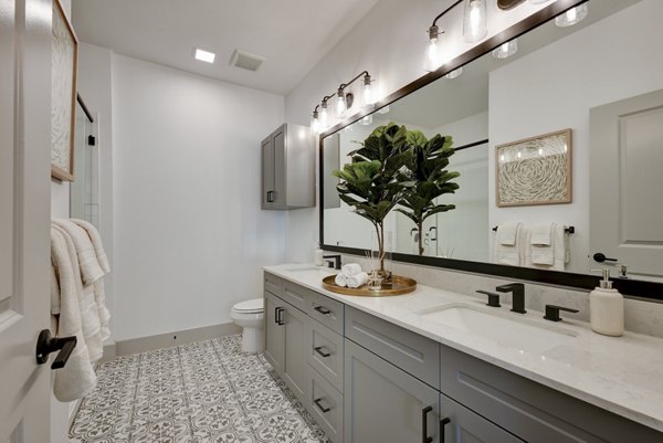 Modern bathroom with sleek fixtures at Arbolada Apartments luxury community