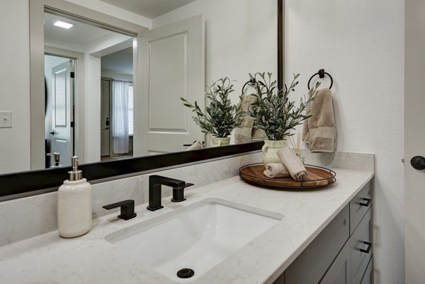 Bathroom featuring luxury fixtures and modern design at Arbolada Apartments