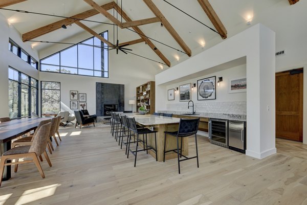 Modern clubhouse with cozy seating and entertainment options at Arbolada Apartments