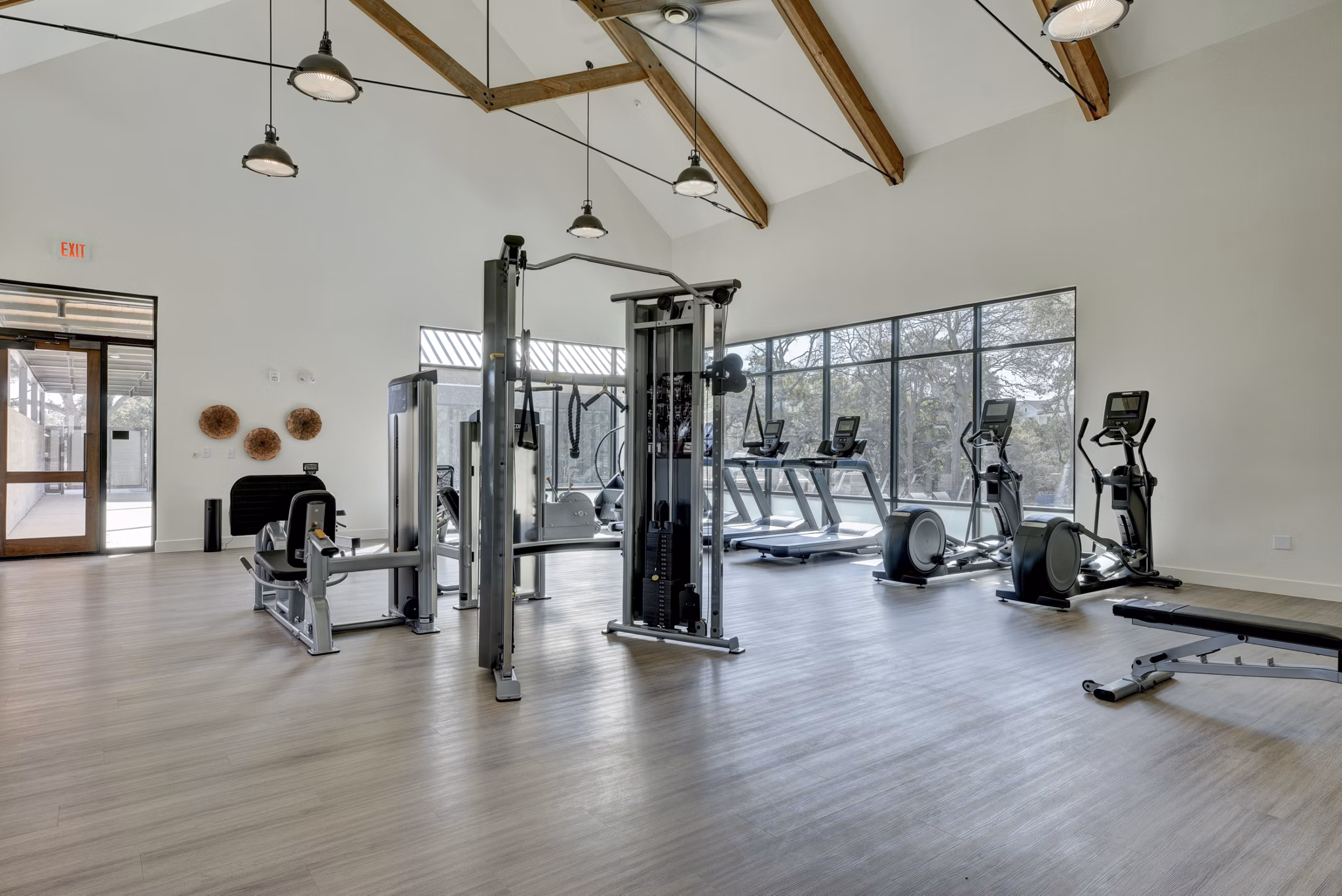 Fully-equipped fitness center at Arbolada Apartments with modern workout machines and free weights