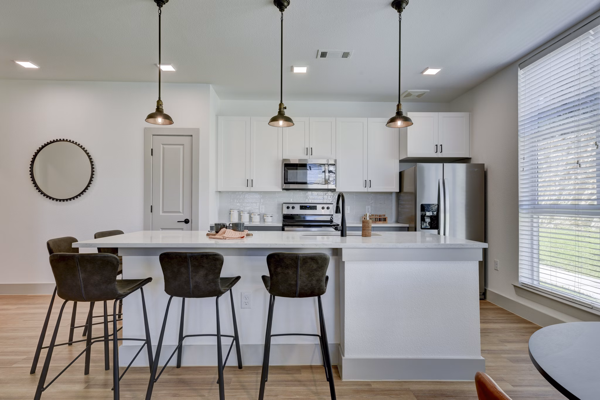 Modern kitchen with stainless steel appliances at Arbolada Apartments