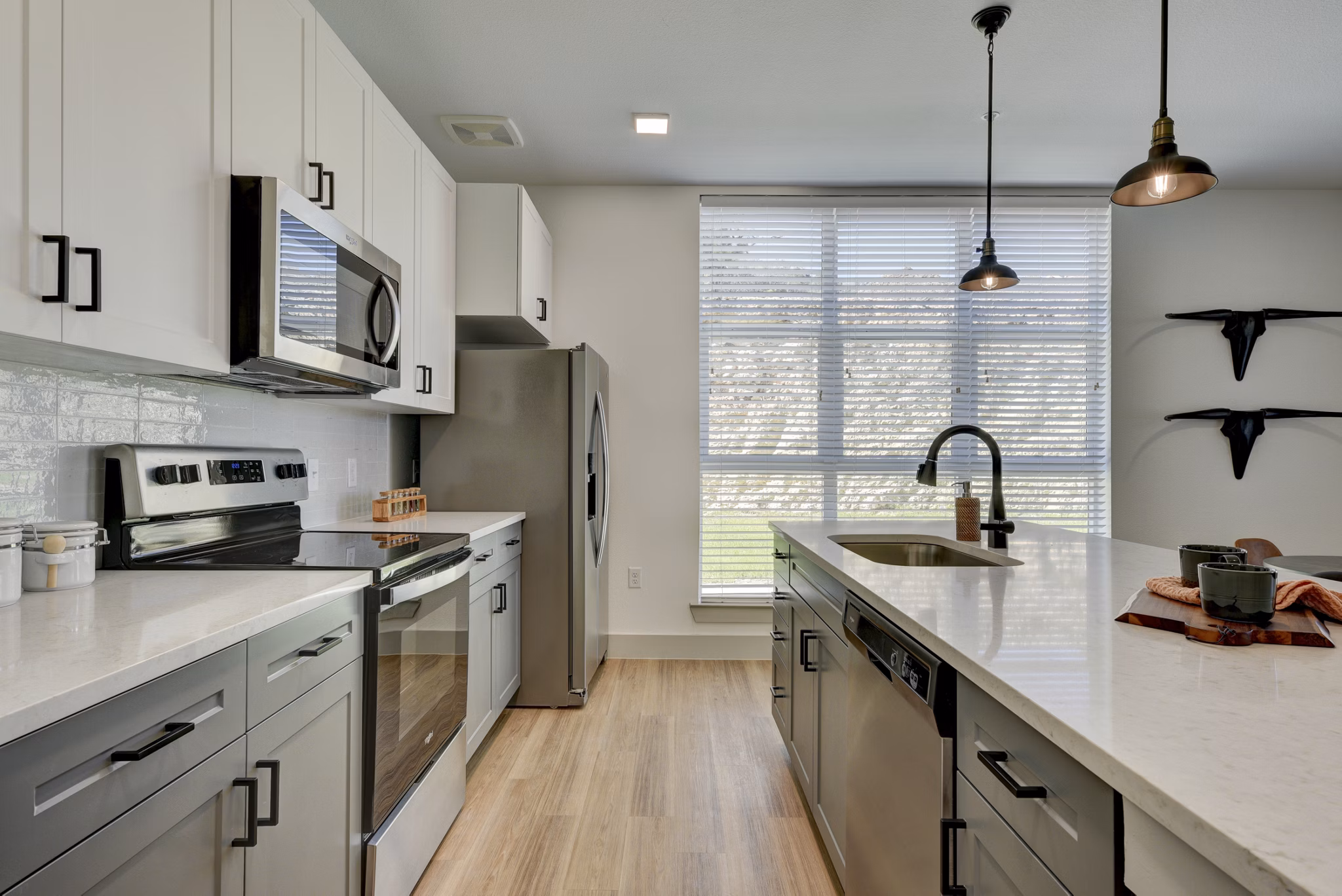 Modern kitchen with stainless steel appliances in Arbolada Apartments, luxury property