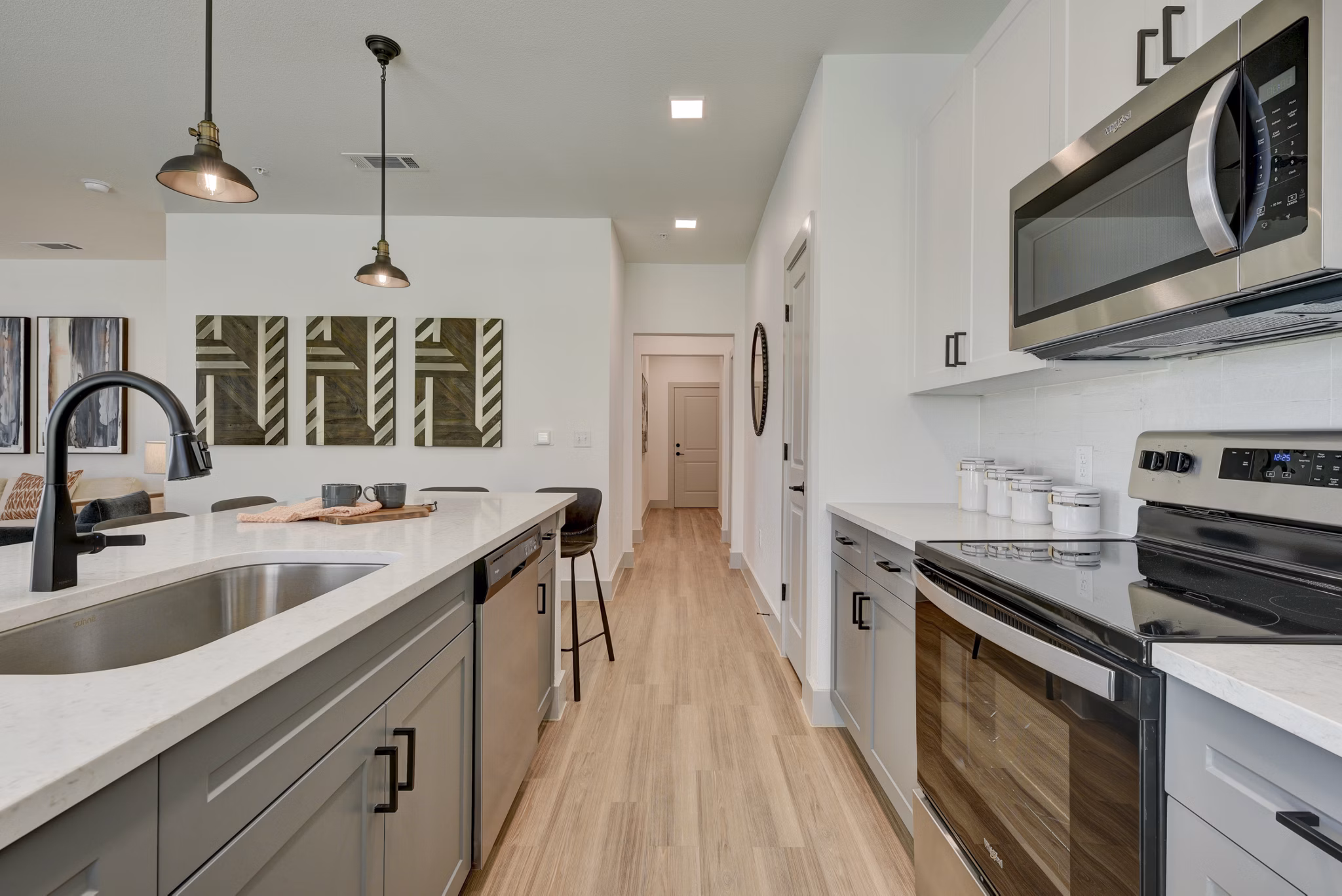 Modern kitchen with stainless steel appliances at Arbolada Apartments