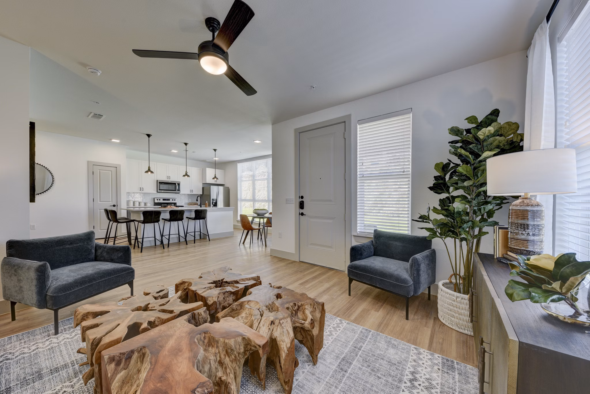 Spacious living room with modern decor in Arbolada Apartments, showcasing luxury apartment living