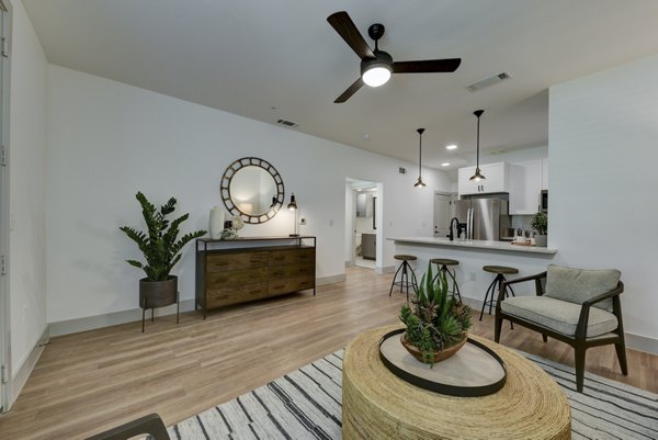 Spacious living room with modern furnishings at Arbolada Apartments