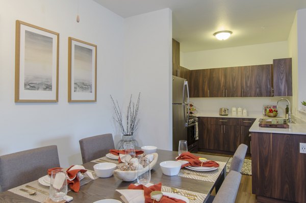 Dining area with modern furnishings at Britton Place Apartments, featuring elegant decor and natural lighting for a luxurious living experience