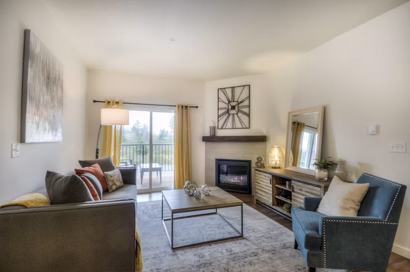 Modern living room with sleek furnishings and large windows at Britton Place Apartments