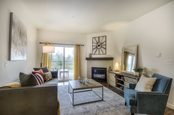 Modern living room with sleek furnishings and large windows at Britton Place Apartments