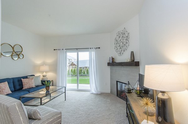 Living room featuring modern furniture and large windows at Britton Place Apartments in Lacey, WA