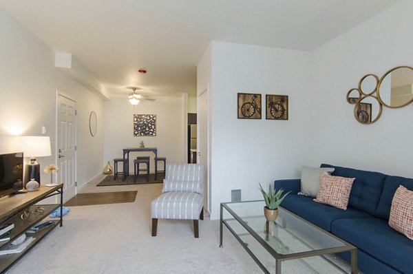 Open-concept living room with modern decor and natural light at Britton Place Apartments