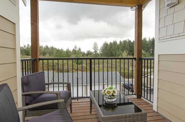 Patio area with stylish seating and lush greenery at Britton Place Apartments