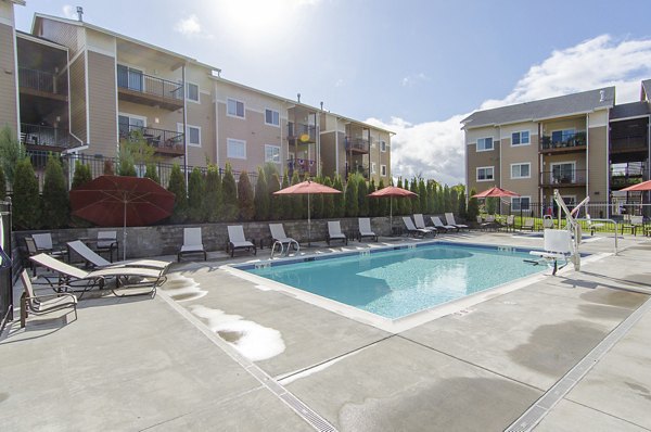 Resort-style pool with lounge chairs at Britton Place Apartments