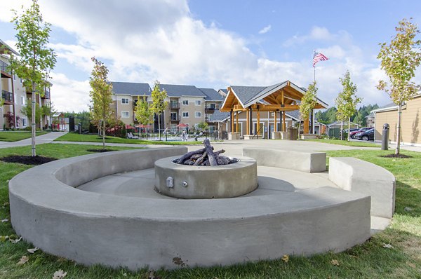 Fire pit lounge area at Britton Place Apartments featuring comfortable seating for residents