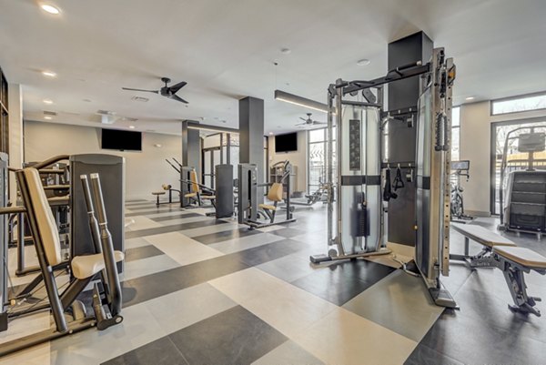 Modern fitness center at The Plaza at Pikes Peak Apartments featuring state-of-the-art equipment for an enhanced workout experience