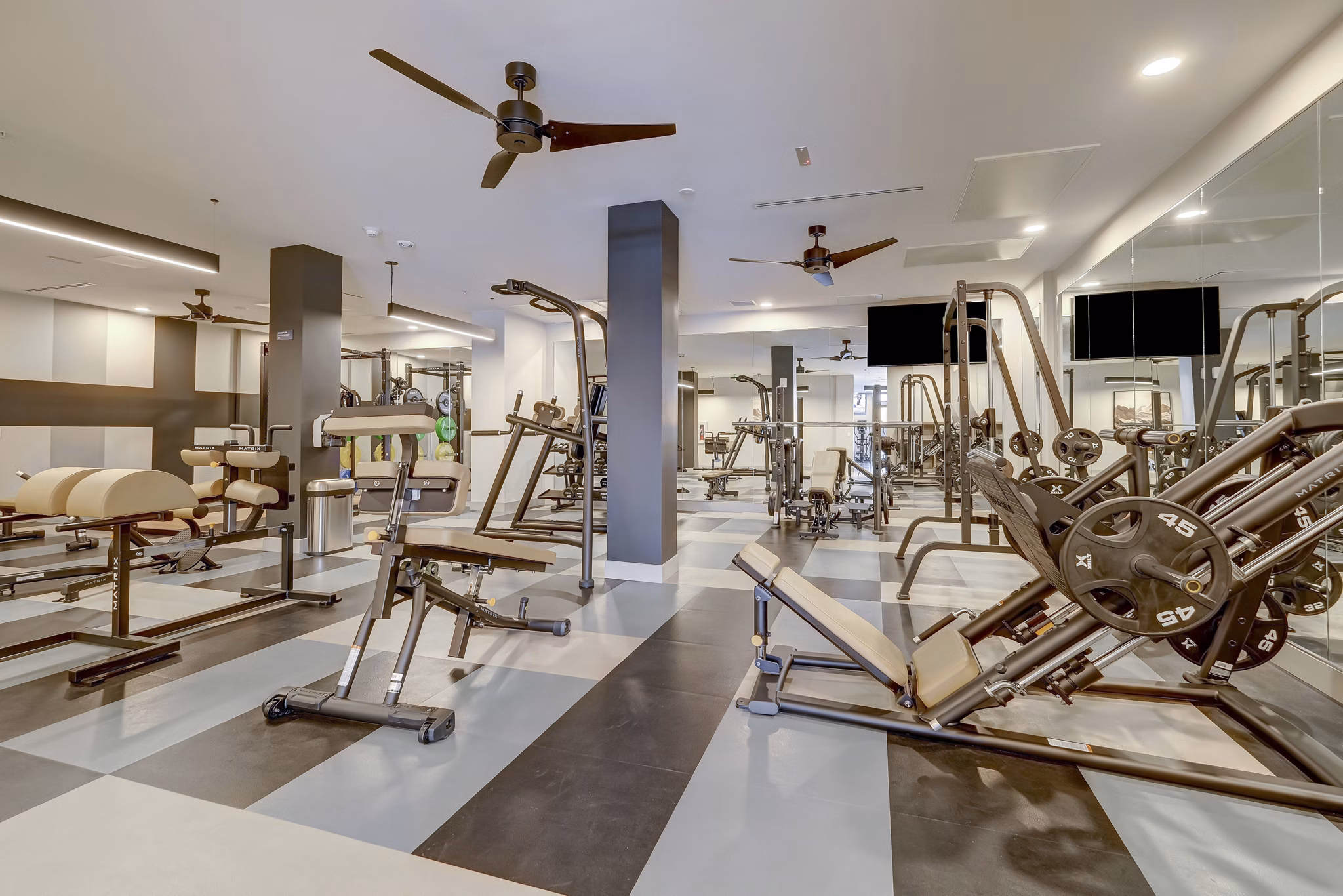 Fitness center with modern gym equipment at The Plaza at Pikes Peak Apartments