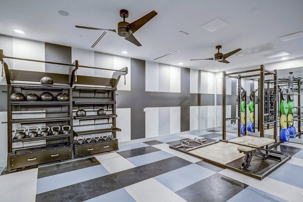 State-of-the-art fitness center at The Plaza at Pikes Peak Apartments with modern exercise equipment and spacious workout areas