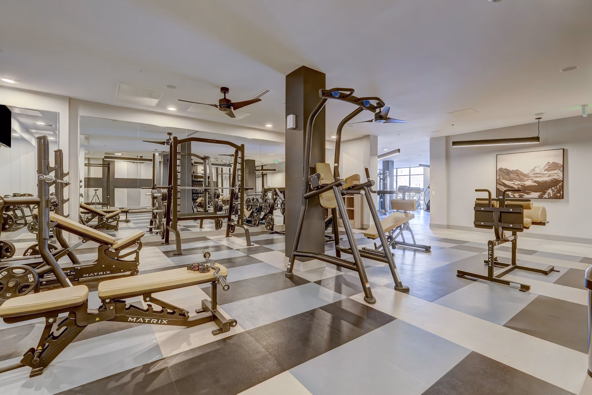 State-of-the-art fitness center at The Plaza at Pikes Peak Apartments featuring modern equipment