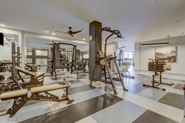 State-of-the-art fitness center at The Plaza at Pikes Peak Apartments featuring modern equipment