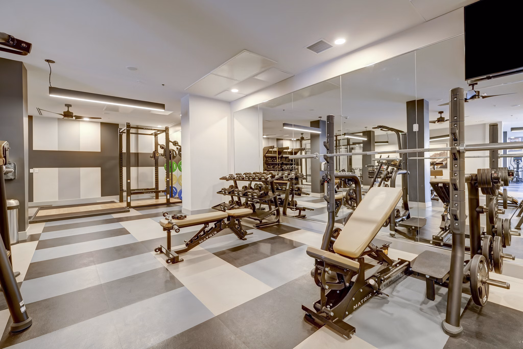 Modern fitness center featuring top-of-the-line equipment at The Plaza at Pikes Peak Apartments