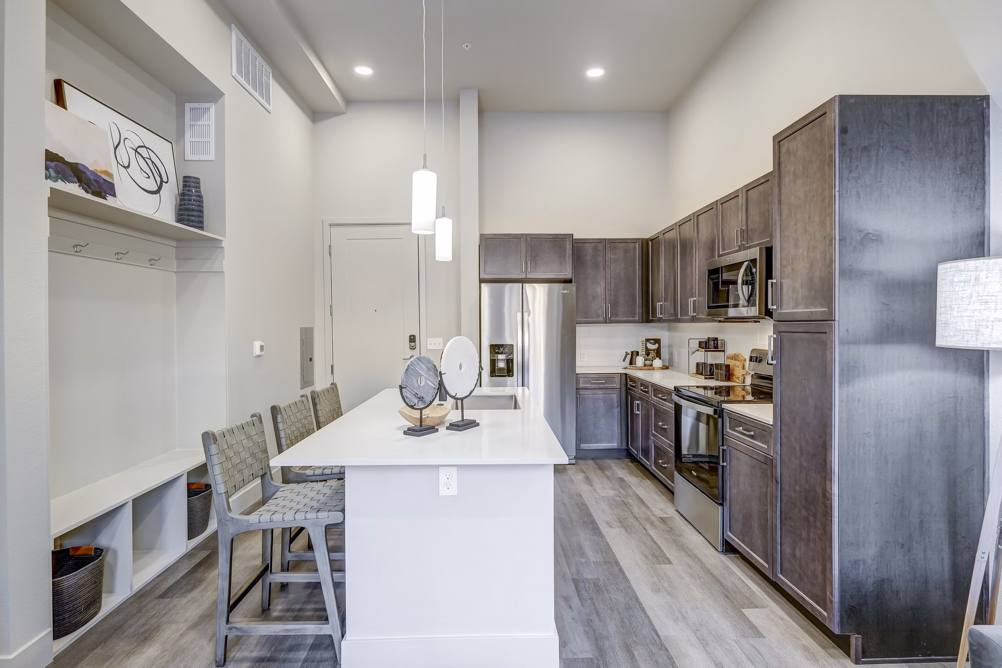 Modern kitchen with sleek countertops and stainless steel appliances at The Plaza at Pikes Peak Apartments