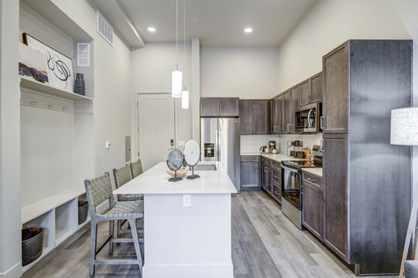 Modern kitchen with sleek countertops and stainless steel appliances at The Plaza at Pikes Peak Apartments