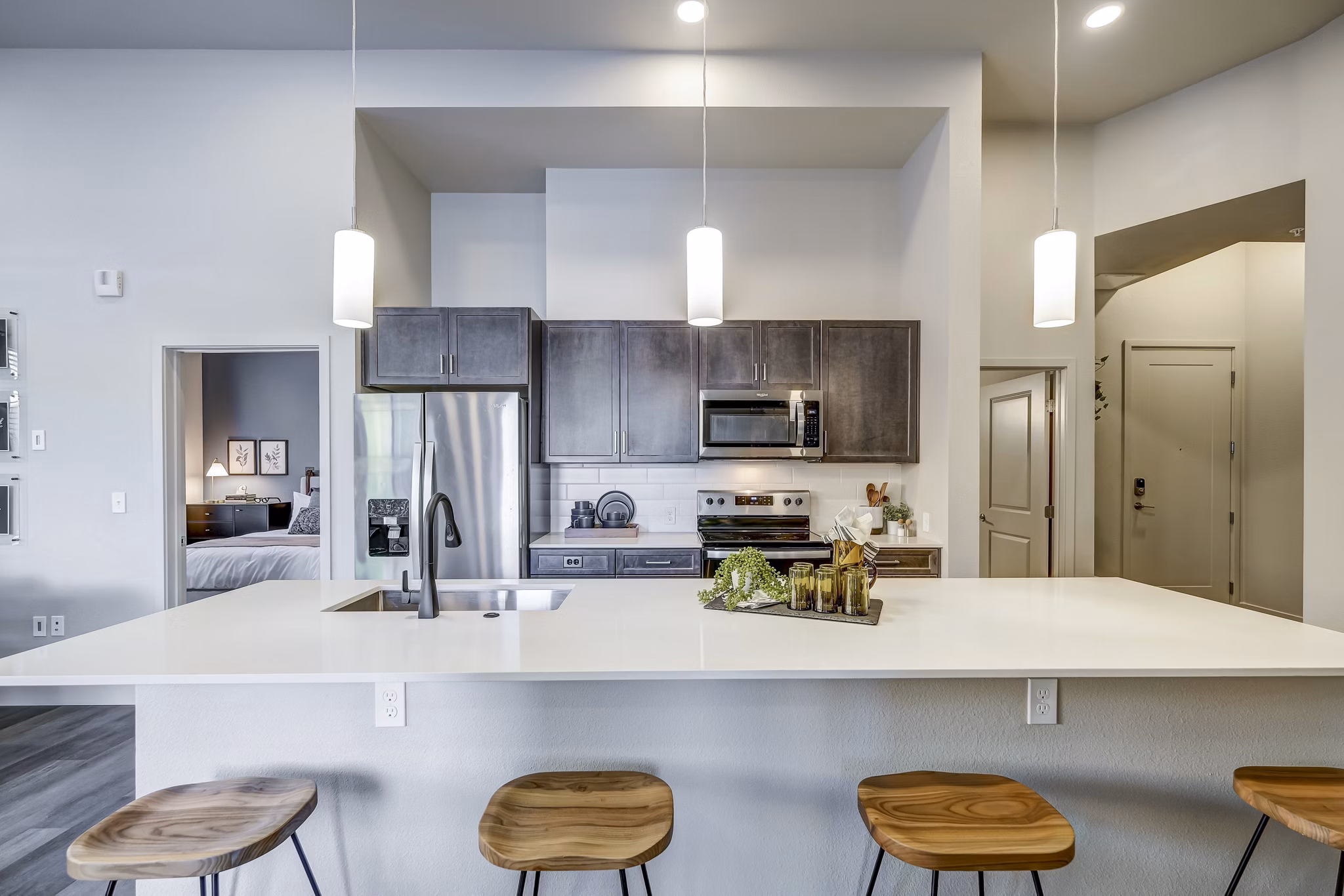 Modern kitchen with stainless steel appliances at The Plaza at Pikes Peak Apartments