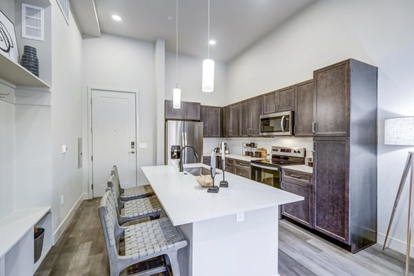 Sleek kitchen with stainless steel appliances at The Plaza at Pikes Peak Apartments