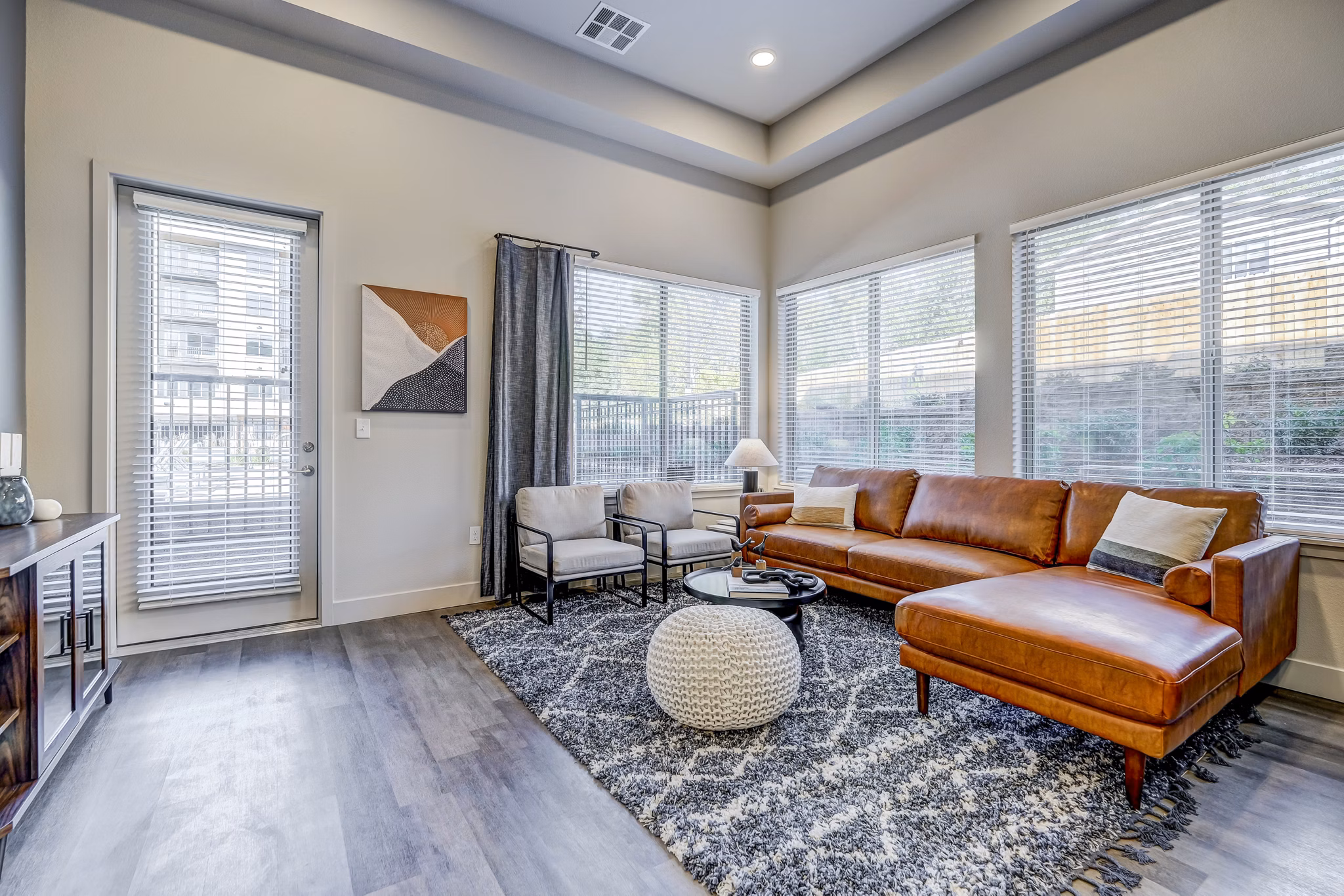 Spacious and modern living room with sleek furniture at The Plaza at Pikes Peak Apartments, showcasing luxury Greystar living