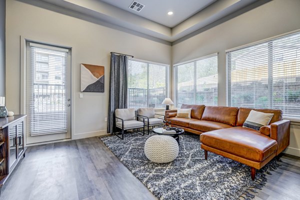 Spacious and modern living room with sleek furniture at The Plaza at Pikes Peak Apartments, showcasing luxury Greystar living