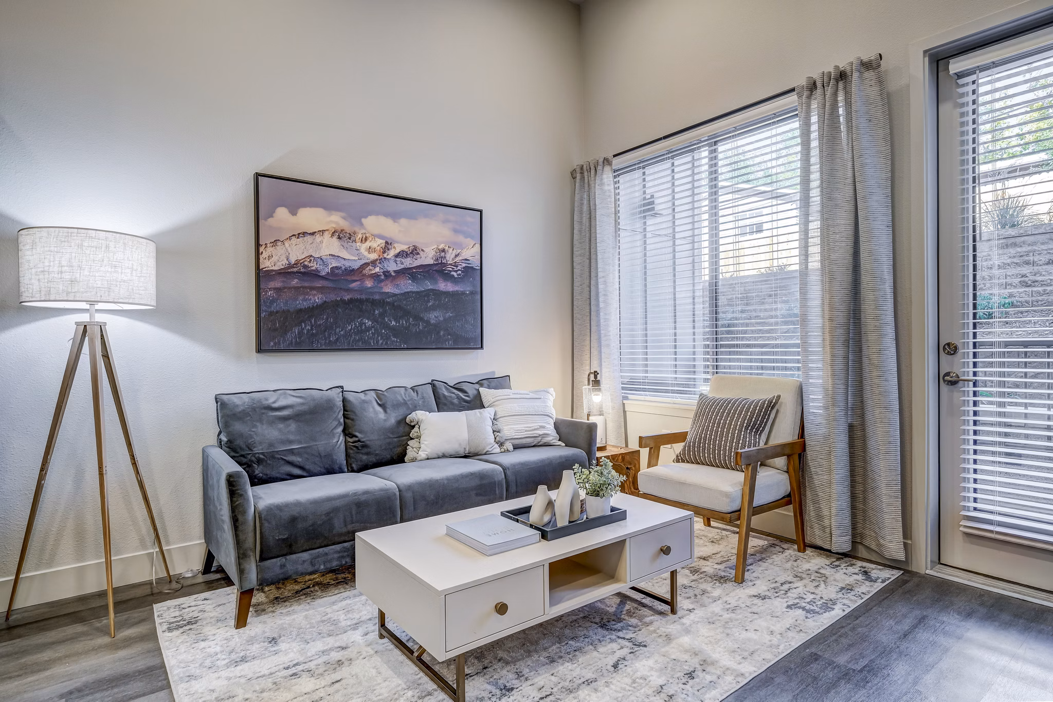 Spacious living room with modern decor in The Plaza at Pikes Peak Apartments
