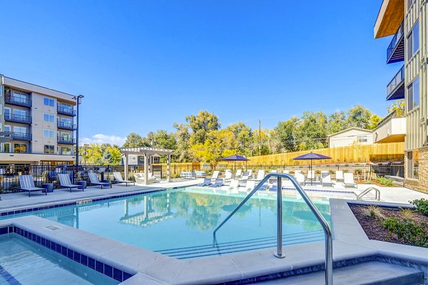 Luxurious pool at The Plaza at Pikes Peak Apartments with mountain views, perfect for relaxation and unwinding in a serene environment