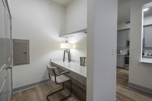 Home office with modern desk and ergonomic chair at Seville Uptown Apartments, perfect for remote work and productivity