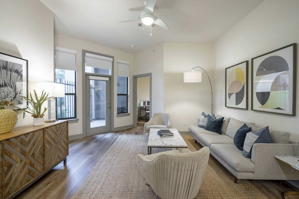 Cozy living room with modern furniture and decor in Seville Uptown Apartments, a luxury property by Greystar