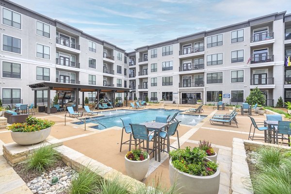 Courtyard with lush greenery at Seville Uptown Apartments, offering luxury outdoor spaces for relaxation and gatherings in the heart of the city