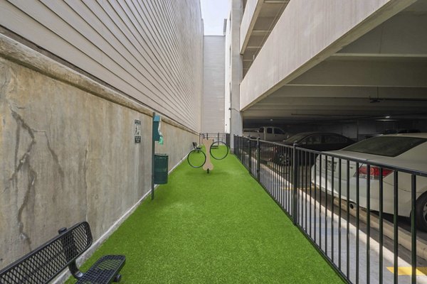 Dog-friendly play area at Seville Uptown Apartments featuring fenced dog park with agility equipment