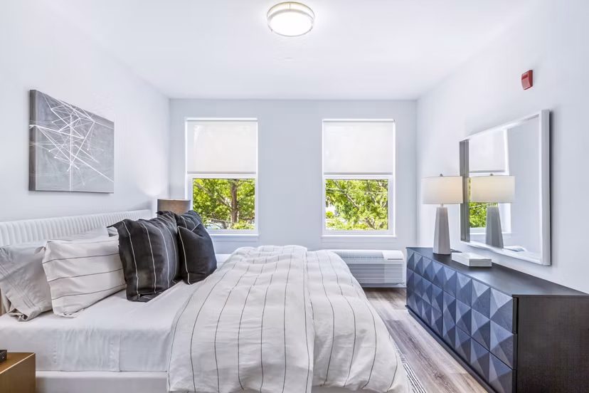 Cozy bedroom with modern furnishings at The Park at Woodbridge Station Apartments, ideal for comfort and relaxation